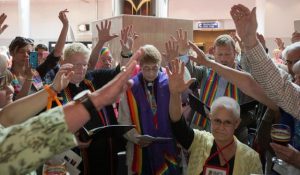 Supporters gather around Susan Laurie (center) -- an outspoken lesbian activist--to proclaim her unauthorized ordination at the 2016 United Methodist General Conference. Photo by Mike DuBose, UMNS
